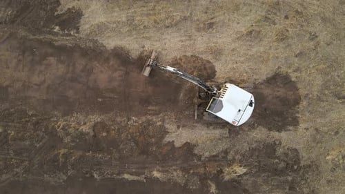 Earth Moving Tractor Preparing Place for Future House Foundation Construction