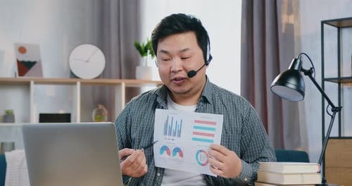 Adult Presenting Business Charts During Video Conference