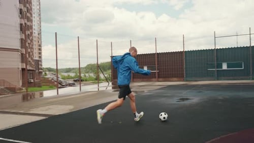 Man Practicing Soccer Skills on Outdoor Court