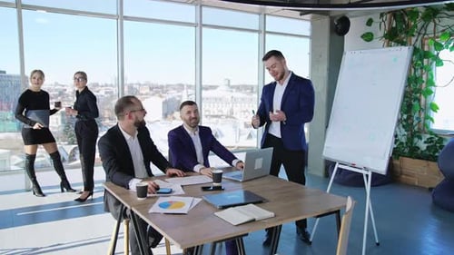 Business people collaborating in the office. Male team at the table working at the foreground.