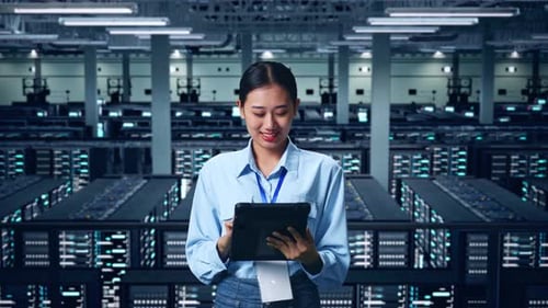 An Asian Business Woman Using Tablet In Data Center