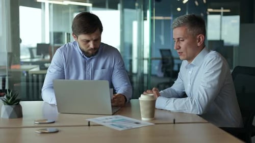Men Meeting in Modern Office Using Laptop