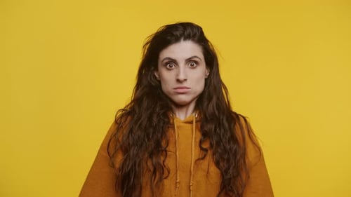 Woman's Surprised Expression in Studio Setting