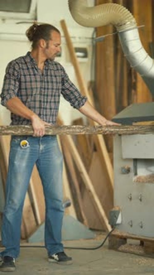 Carpenter Processing a Raw Log on a Planing Machine