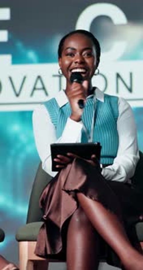 Woman Giving Corporate Presentation With Tablet and Microphone