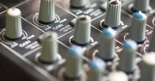 Close Up Of Professional Audio Mixing Console Input Gain Control Knobs. selective focus, slider shot