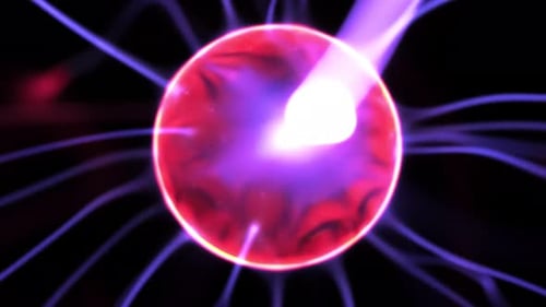 Bright Plasma Ball Arcs Against Dark Background