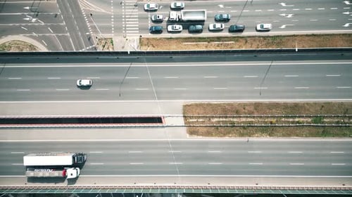 Urban veins: Drone footage over highway interlaced, reflecting non-stop flow of city traffic. Vehicu