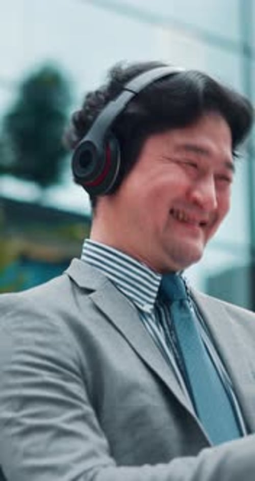 Japanese, business man and city with headphones, yes and podcast with phone scroll and playlist