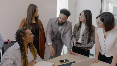 A Diverse Business Team Actively Collaborating and Engaging in a Modern Office Environment