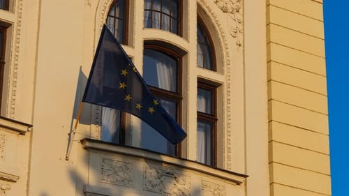 EU Flag Waving on Building During Golden Hour