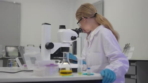 Researchers conduct experiments in laboratory with microscopes and samples
