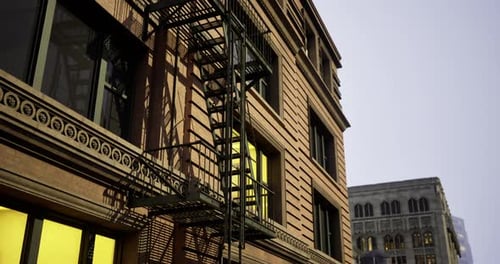 Historic Building Facade with Fire Escape in Urban Setting at Dusk