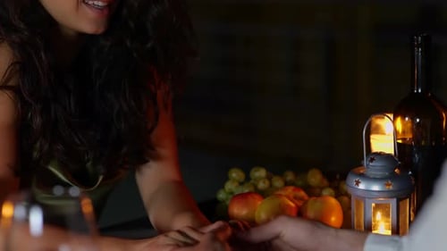 Romantic Couple Holding Hands During Candle-Lit Dinner