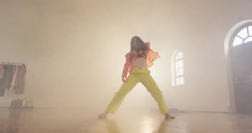 Portrait of caucasian female dancer dancing in dance studio, slow motion