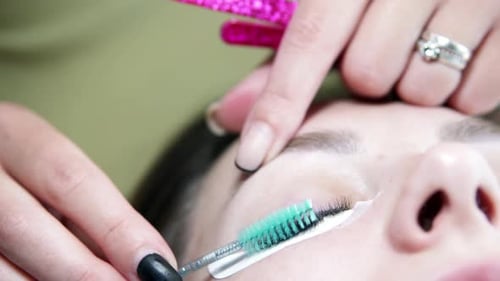 Eyelash Extension Treatment for a Woman in Beauty Salon