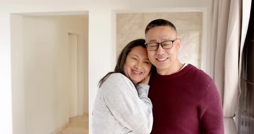 Affectionate Couple Smiling and Embracing Indoors