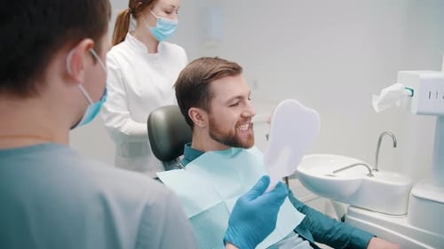 Man Smiling After Dental Checkup at Dentist Office