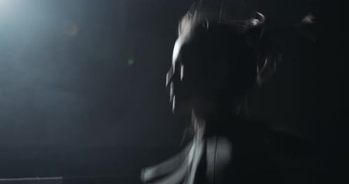 Athletic woman skipping rope workout in dark room