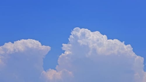 Fluffy White Clouds Against a Vivid Blue Sky