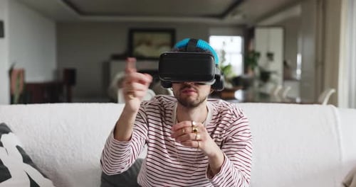 Man Experiencing Virtual Reality on Couch in Living Room