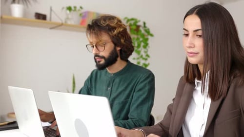 Successful Businesswoman Discussing Project with Colleague in the Office