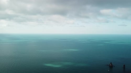 Aerial View From Above on Calm Azure Sea and Volcanic Rocky Shores