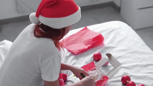 Woman Decorating Christmas Ornaments at Home