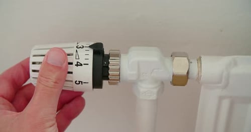 Radiator know turning up heating, close up