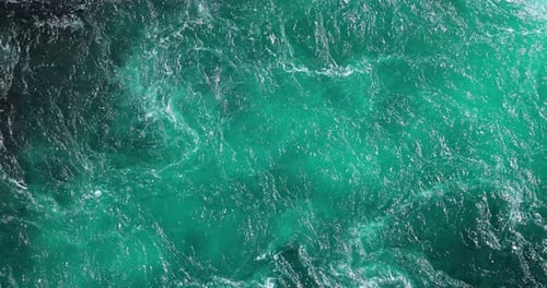 Blue waves of water of the river and the sea meet each other during high tide and low tide.