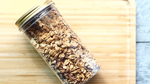 Granola in Jar Overhead on Cutting Board