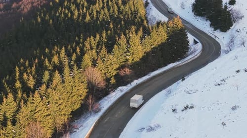 Snowy Forest Road With Vehicle White Van Moving Along Slippery Snowy Forest Pathway Under Sunlight