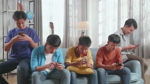 Five Young Adults Using Smartphones on Couch Indoors