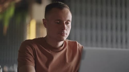 Portrait Of Smart Man Working With Laptop In Cafe Remote Work In Internet IT Professional