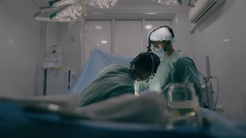 Team of Two Doctors Men Surgeons Processing Surgical Operation Using Endoscopic Medical Instruments