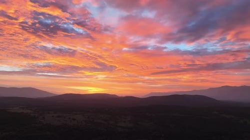 flight at sunset in a valley visualizing in a slight turn to the right the mountains and forests and