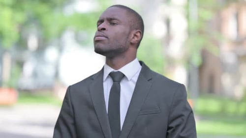 Man Wearing Suit Looking at Watch Outside