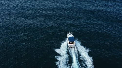 Aerial view to motor yacht floating in the sea