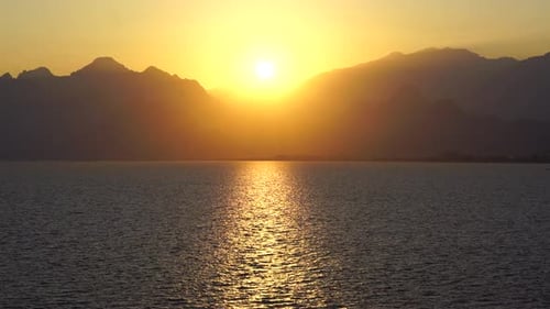 Serene Sunrise Over Vast Sea – Golden Sunlight and Reflective Path on Water in 4K