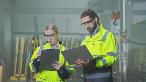 Engineers Discussing Project in Modern Factory Setting
