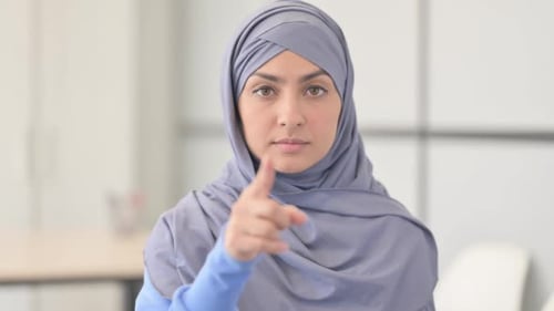 Woman in Hijab Points at the Camera