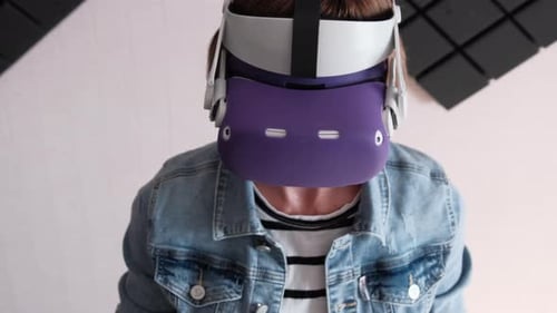 Woman Using Virtual Reality Headset and Controllers