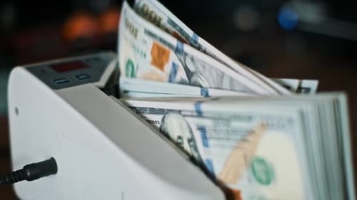 Money Counter Machine Counts Stacks of Dollar Bills