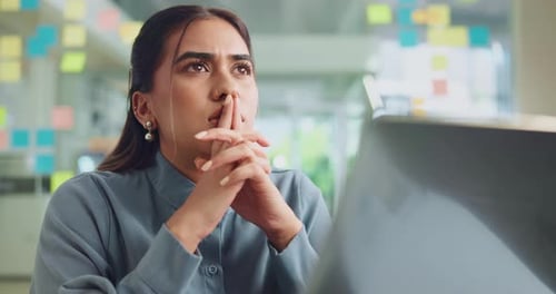 Frown, laptop and thinking with business woman in office for inspiration or problem solving