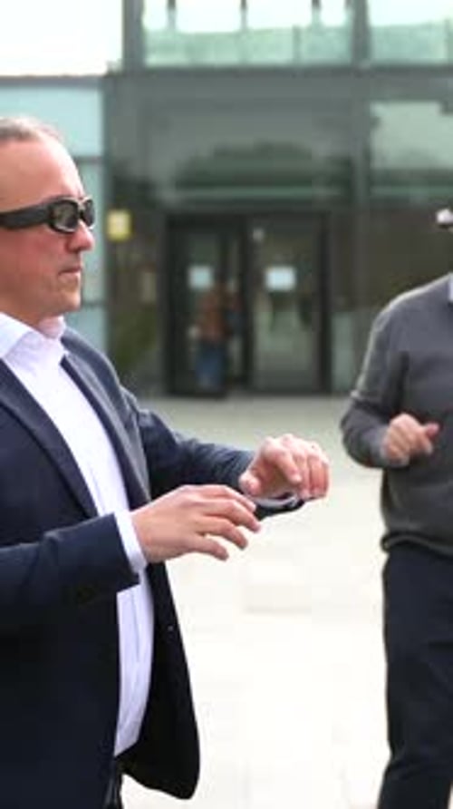Men Demonstrating New Tech Glasses Outside Office