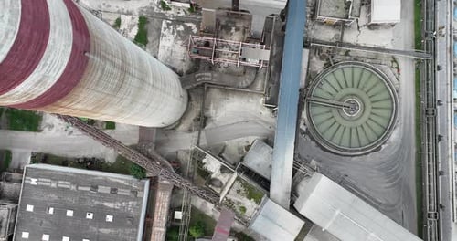 Aerial Drone Shot of Coal Power Plant with Two High Cooling Towers Next to Blue River