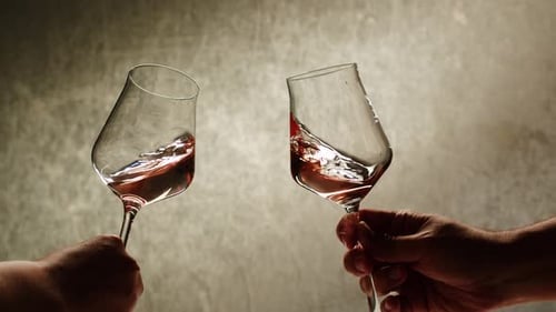 Rose Orange or White Wine Bottle and Glass Against a Sunset in a Peaceful Vineyard Pouring of