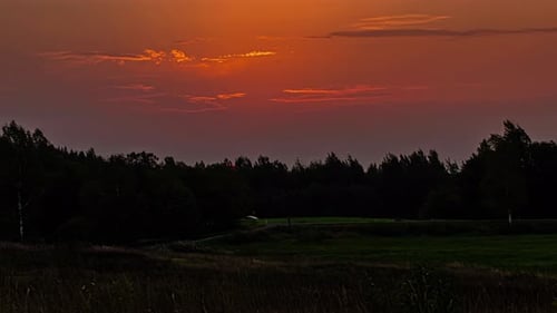 Sunrise above vibrant rural landscape, fusion time lapse