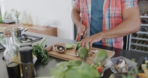 Adult Prepares Vegetables in Bright Kitchen