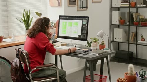 Person Designs App Interface at Home Office Desk